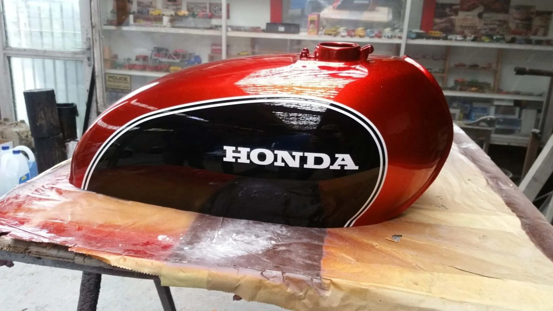Honda motorcycle tank sprayed candy red by Lee Niven, Dumfries