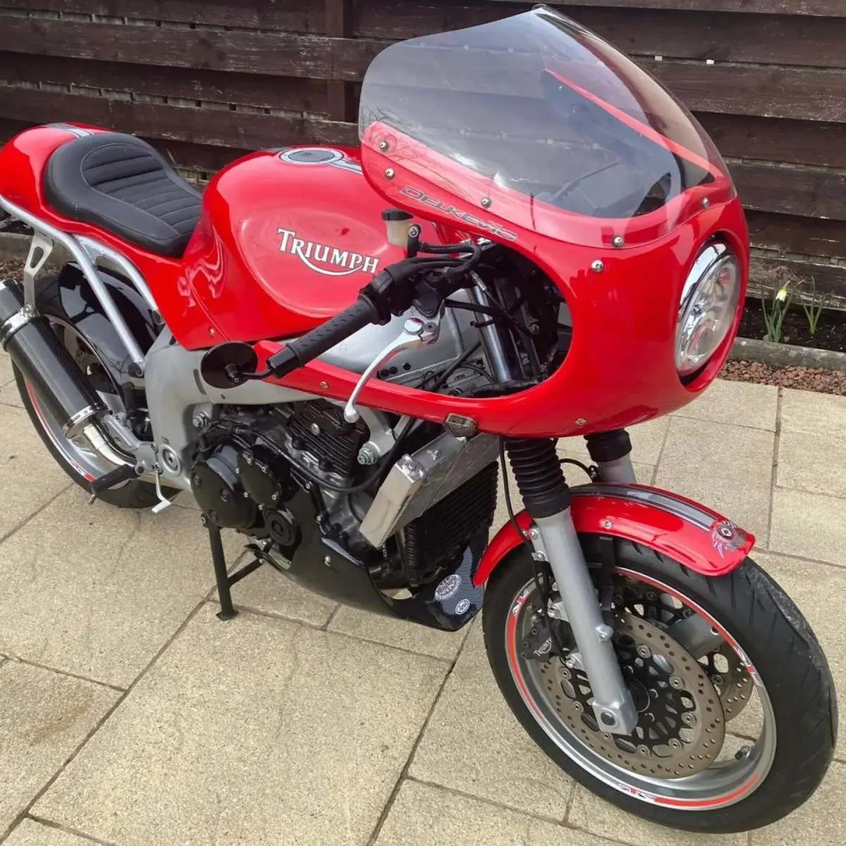 Red Triumph cafe racer motorcycle painted by Lee Niven, Dumfries
